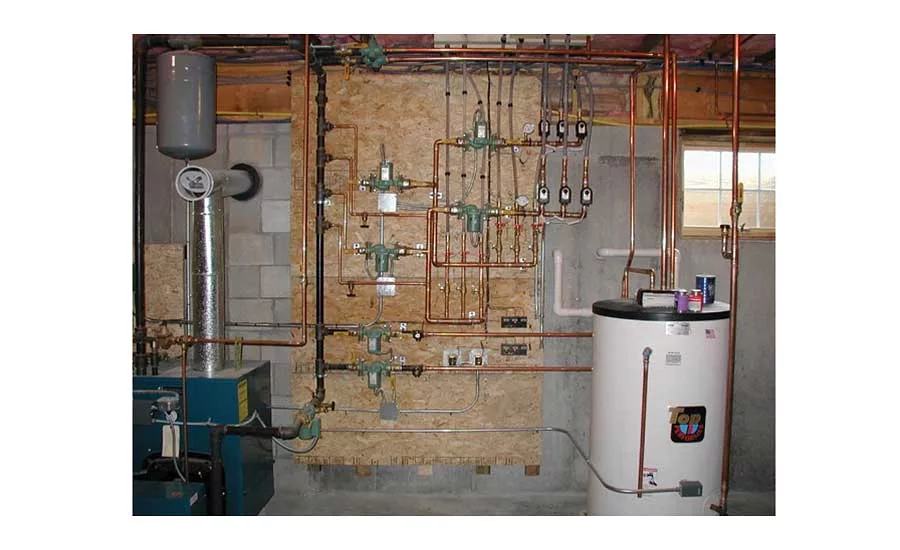As you step off the basement stairs you see a boiler, several circulators, zone valves