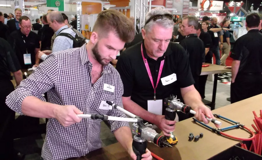 Contractors visiting the REHAU booth got a product demonstration mixed with a feeling of competition as they became familiar with the new PEX tools available