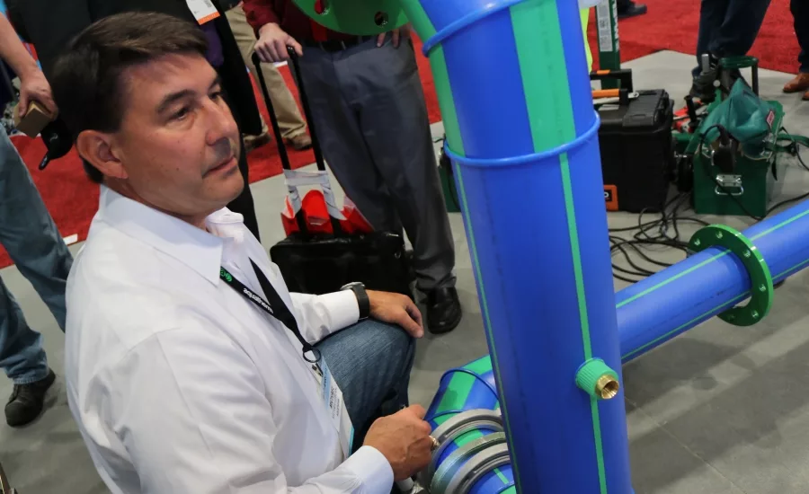 Aquatherm’s Michael LeBlanc helps install polypropylene (PP-R) pipe during a demonstration at the 2017 AHR Expo in Las Vegas