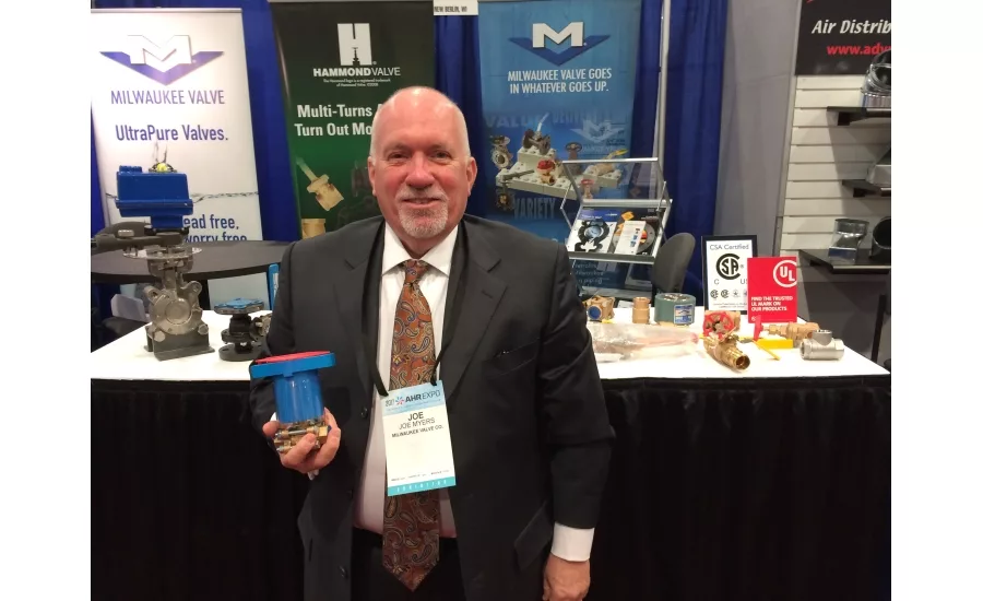 Milwaukee Valve’s Joe Myers poses with the MS Insulator valve handle during the 2017 AHR Expo in Las Vegas