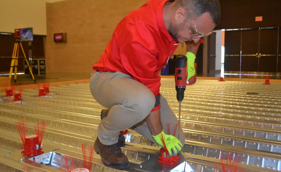 A Hilti rep demonstrates the company’s new Cast-in Device for Metal Deck