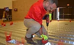 A Hilti rep demonstrates the company’s new Cast-in Device for Metal Deck