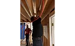 Attendees install radiant tubing in the ceiling of Legend University’s training