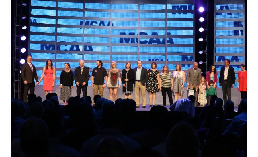 Outgoing MCAA president Tom Stone is joined onstage by his fiancée, Sharon Glynn, as well as the rest of his family during MCAA 2017 in San Diego
