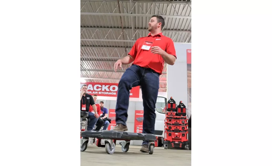 Senior Product Manager Matt Vargo steps on a dolly –a new product from Milwaukee Tool