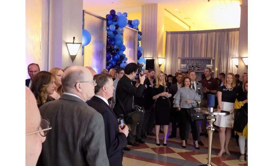 The invited guests anxiously await the official opening of the new Moen showroom