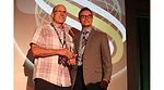 Tom Piscitelli (left) receives the Tom McCart Award from BNP Media Group Publisher Mike Murphy Sept. 8 at the 2017 Service World Expo in Las Vegas