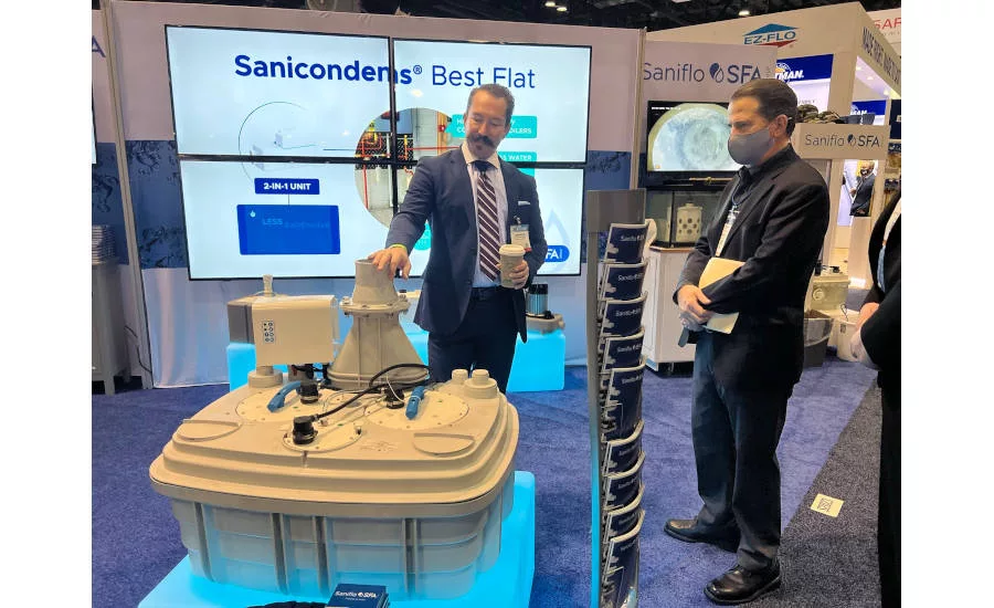 Christopher Peterson, national sales manager for Saniflo, gives BNP Media Plumbing Group Publisher Dan Ashenden, a tour of the manufacturer’s booth at KBIS 2022.
