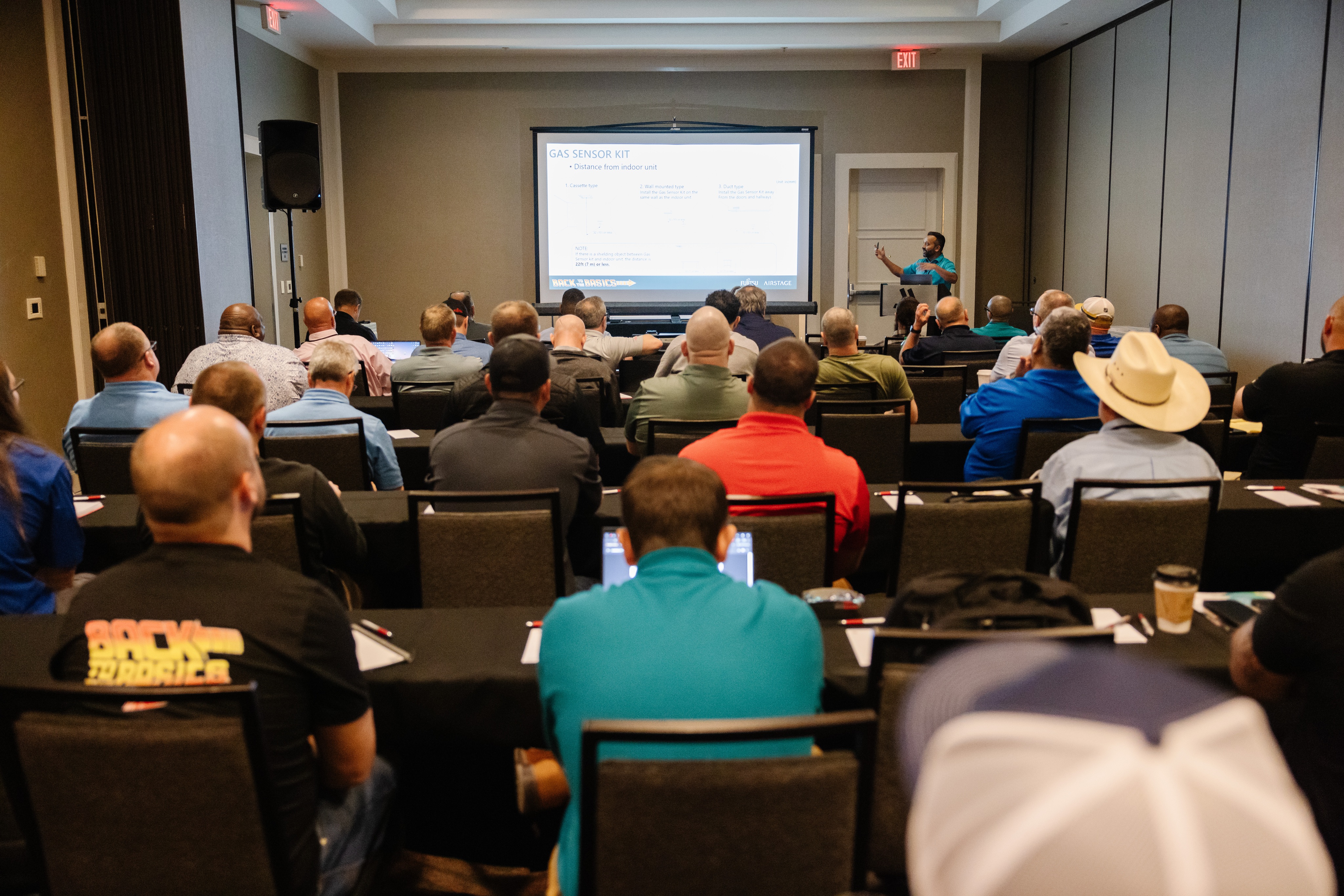 Attendees of the TSA Conference watching a presentation. 