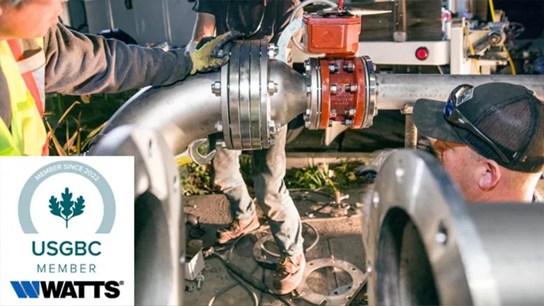 Several people working on machinery, with a logo for Watts and USGBC. 