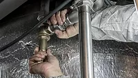 New Drexel study: Why smaller pipes and higher flow improve water quality A plumber installing a pipe.