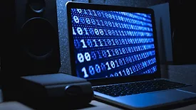 A computer screen showing a sequence of 0s and 1s. 