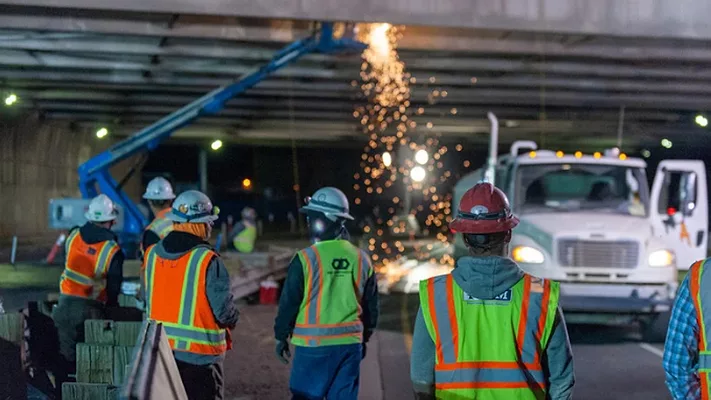 Several construction workers working. 