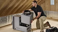 A person installing the Honeywell Home Whole House Dehumidifier. 