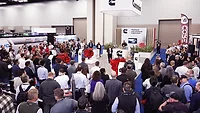 Several attendees gather around a Cummins demonstration. 