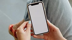 A person holding an iPhone.