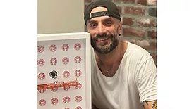 Regis Saragosti, former Saniflo U.S.A. CEO, posing with his art. 