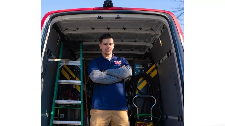A worker standing in front of a van.