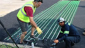 Installing a snowmelt system into a driveway.