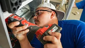 A contractor installs a heat pump.