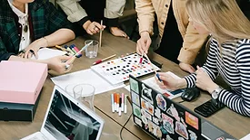 Several people discussing colors and marketing. 