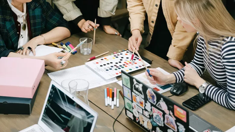 Several people discussing colors and marketing. 