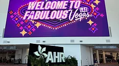 Welcome to Fabulous Las Vegas marquee in shades of purple above the AHR sign.