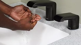 A person washing their hands. 
