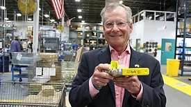 A representative from Aalberts in the company's factory holding the "Apollo."