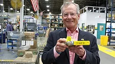 A representative from Aalberts in the company's factory holding the "Apollo."