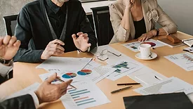 Several people at a table discussing business. 