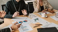Several people at a table discussing business. 