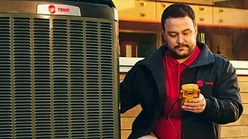A technician working on a Trane Technology product.