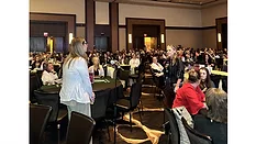 A woman speaking to a crowd. 