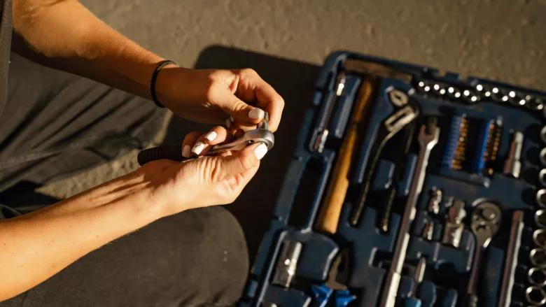 A woman with a toolbox.