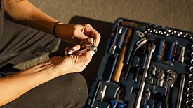 A woman with a toolbox.