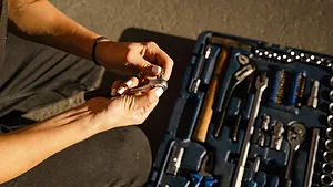 A woman with a toolbox.