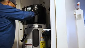 A technician installs an A. O. Smith Votrex 120V Heat Pump Water Heater.
