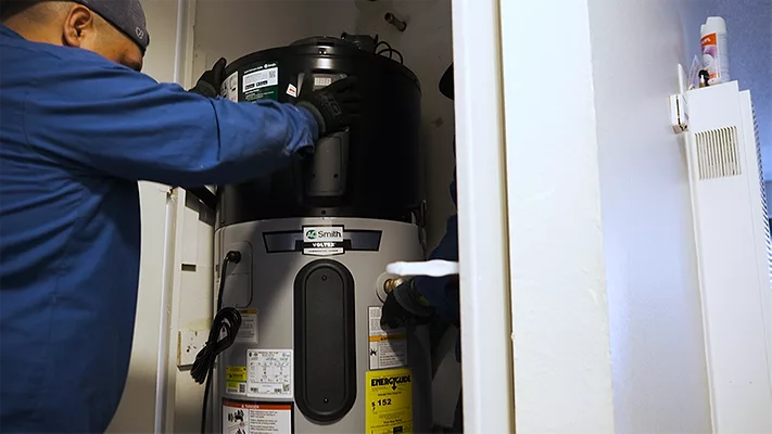 A technician installs an A. O. Smith Votrex 120V Heat Pump Water Heater.