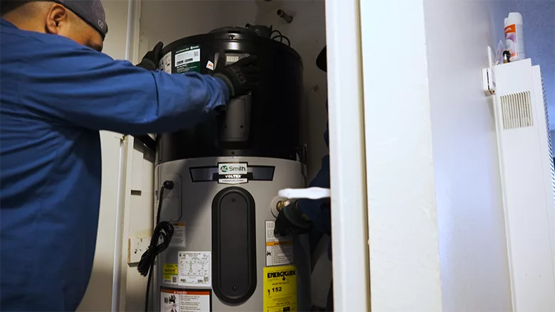 A technician installs an A. O. Smith Votrex 120V Heat Pump Water Heater.