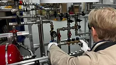 An engineer installing a pipe system. 