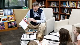 Barton James, ACCA president and CEO, reads to a class of first graders in Little Rock, Arkansas in recognition of National Skilled Trades Day. 