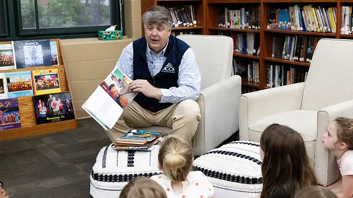 Barton James, ACCA president and CEO, reads to a class of first graders in Little Rock, Arkansas in recognition of National Skilled Trades Day. 