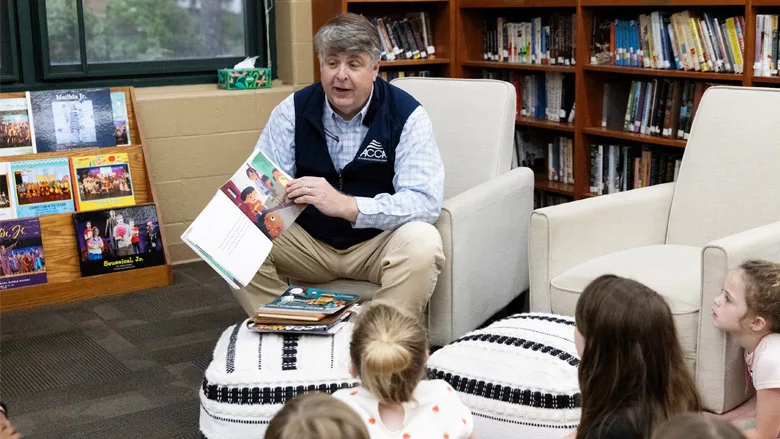 Barton James, ACCA president and CEO, reads to a class of first graders in Little Rock, Arkansas in recognition of National Skilled Trades Day. 