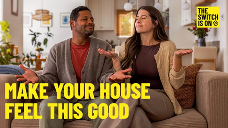 Two home-owners sitting on a couch, with "Make your house feel this good" and "The switch is on" written above them.