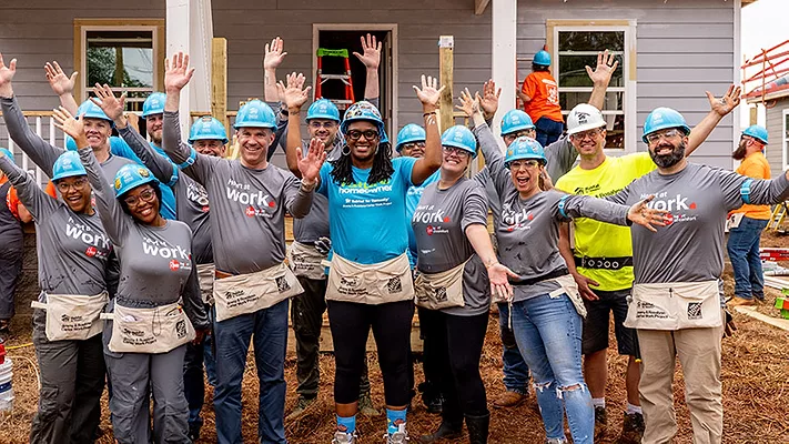 The Rheem team posing in front of a home. 