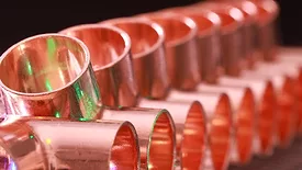 Copper plumbing fittings arranged in a row
