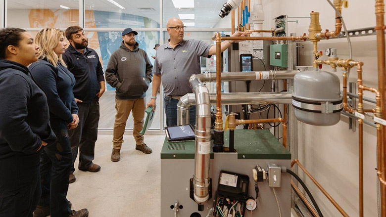PPATEC students (from left) Hanna Lewis and Skylar Buckley, Aero Energy; Jim Cameron, Handyside, Inc., and Neil Baer, Haller Enterprises, listen as Taco Instructor Dave Holdorf makes a point in a PPATEC hydronic lab.