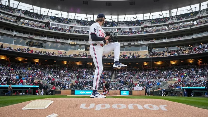 A baseball player preparing a pitch with "Uponor" written on the pitcher's mound. 