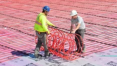 REHAU Introduces Automated Production of RAUMAT Prefabricated Mats Field installation of RAUMAT showcasing fast-roll placement of pre-assembled radiant circuits